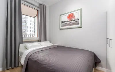 Łóżko lub łóżka w pokoju w obiekcie Warsaw City Travel Apartments