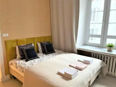 Łóżko lub łóżka w pokoju w obiekcie Poznańska Street Apartment