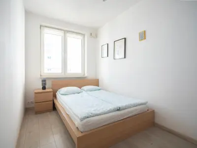 Łóżko lub łóżka w pokoju w obiekcie Extra Green Kabaty Apartament nr 5