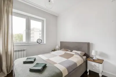 Łóżko lub łóżka w pokoju w obiekcie Apartament Muranów