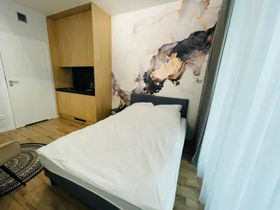 Łóżko lub łóżka w pokoju w obiekcie W Apartments