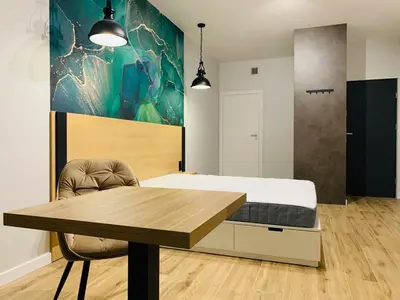 Łóżko lub łóżka w pokoju w obiekcie W Apartments