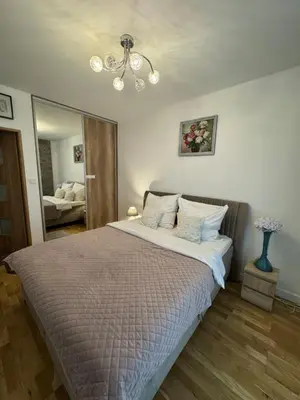 Łóżko lub łóżka w pokoju w obiekcie Apartament Wiatraczna