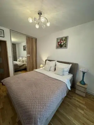 Łóżko lub łóżka w pokoju w obiekcie Apartament Wiatraczna