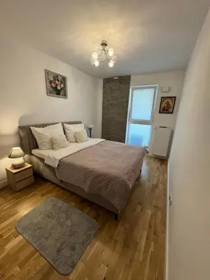 Łóżko lub łóżka w pokoju w obiekcie Apartament Wiatraczna
