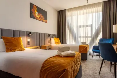 Łóżko lub łóżka w pokoju w obiekcie Hotel Sante