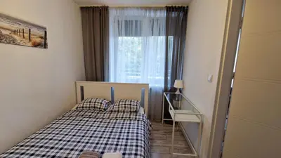 Łóżko lub łóżka w pokoju w obiekcie Krolewska Centrum apartament 4X