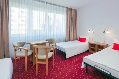 Łóżko lub łóżka w pokoju w obiekcie Aramis