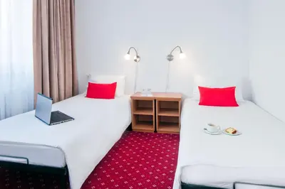 Łóżko lub łóżka w pokoju w obiekcie Aramis
