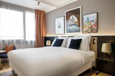 Łóżko lub łóżka w pokoju w obiekcie Golden Tulip Warszawa Centrum