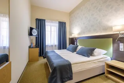 Łóżko lub łóżka w pokoju w obiekcie Hotel Reytan