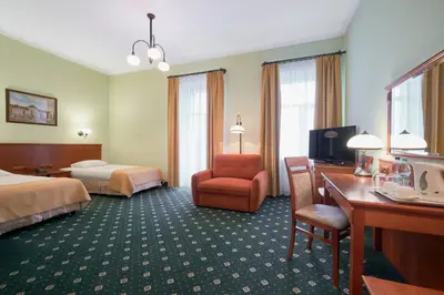 Łóżko lub łóżka w pokoju w obiekcie Hotel Hetman