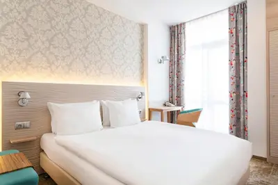 Łóżko lub łóżka w pokoju w obiekcie Hotel Metropol