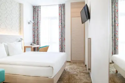 Łóżko lub łóżka w pokoju w obiekcie Hotel Metropol