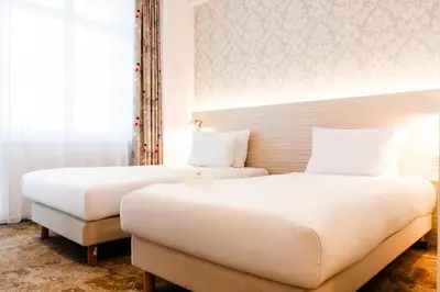 Łóżko lub łóżka w pokoju w obiekcie Hotel Metropol