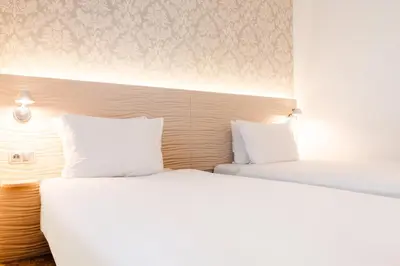 Łóżko lub łóżka w pokoju w obiekcie Hotel Metropol