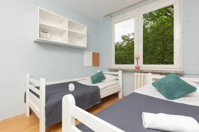 Łóżko lub łóżka w pokoju w obiekcie Warsaw Mokotów Lakeside Family Apartment by Noclegi Renters