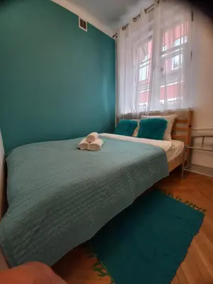 Łóżko lub łóżka w pokoju w obiekcie APARTAMENTY-MI PLAC ZAMKOWY