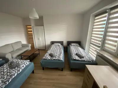 Łóżko lub łóżka w pokoju w obiekcie Pokoje Polinezyjska