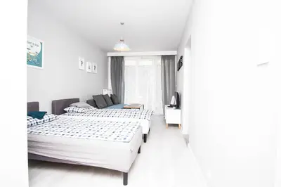 Łóżko lub łóżka w pokoju w obiekcie WAW Apartamenty Cybernetyki