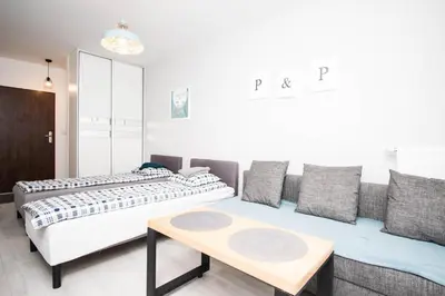 Łóżko lub łóżka w pokoju w obiekcie WAW Apartamenty Cybernetyki