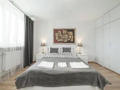 Łóżko lub łóżka w pokoju w obiekcie Sliska 10 Apartament II