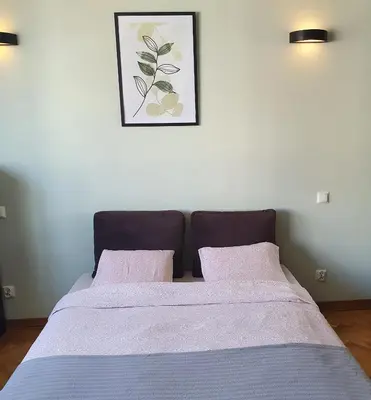 Łóżko lub łóżka w pokoju w obiekcie Center Apartment