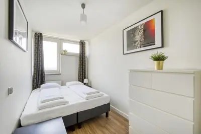 Łóżko lub łóżka w pokoju w obiekcie Labo Apartment Ogród Saski
