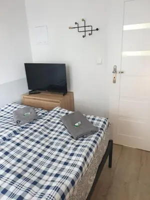 Łóżko lub łóżka w pokoju w obiekcie WAW Pokoje Ursynów