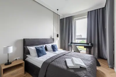 Łóżko lub łóżka w pokoju w obiekcie P&O Apartments Rydygiera II