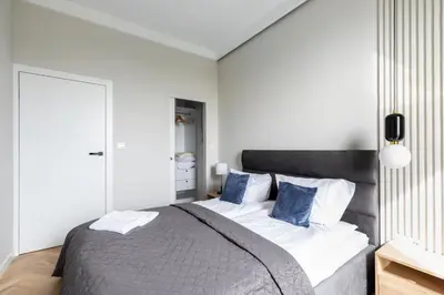 Łóżko lub łóżka w pokoju w obiekcie P&O Apartments Rydygiera II