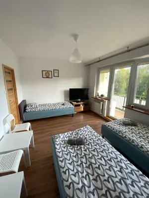 Łóżko lub łóżka w pokoju w obiekcie Pokoje Bora-Komorowskiego