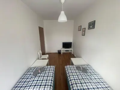 Łóżko lub łóżka w pokoju w obiekcie Pokoje Bora-Komorowskiego