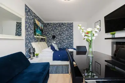 Telewizja i/lub zestaw kina domowego w obiekcie UnitApartments Rondo ONZ 3-pokojowe Apartamenty w Centrum Warszawy 1-8 osób Parking Metro WIFI Winda