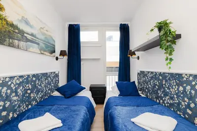 Łóżko lub łóżka w pokoju w obiekcie UnitApartments Rondo ONZ 3-pokojowe Apartamenty w Centrum Warszawy 1-8 osób Parking Metro WIFI Winda