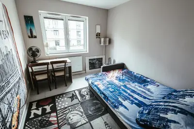 Łóżko lub łóżka w pokoju w obiekcie Apartamenty Bokserska