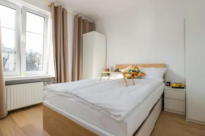 Łóżko lub łóżka w pokoju w obiekcie ShortStayPoland Piekarska (B104)