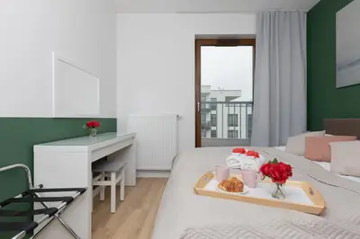 Łóżko lub łóżka w pokoju w obiekcie Warsaw Apartment Postępu with Parking by Noclegi Renters