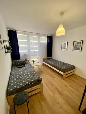 Łóżko lub łóżka w pokoju w obiekcie Warszawa Centrum Pokoje