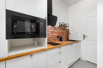 Kuchnia lub aneks kuchenny w obiekcie Nowy Świat 47a by Homeprime