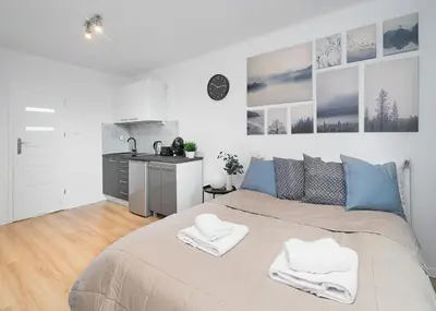 Łóżko lub łóżka w pokoju w obiekcie Central Apartments Grzybowska