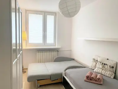 Łóżko lub łóżka w pokoju w obiekcie Warszawa Mieszkanie 4
