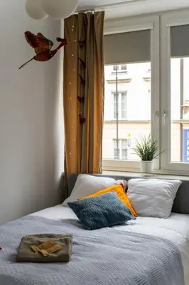 Łóżko lub łóżka w pokoju w obiekcie Warsaw Concierge Miodowa