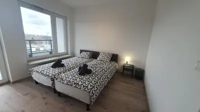 Łóżko lub łóżka w pokoju w obiekcie Pokoje Oszmiańska