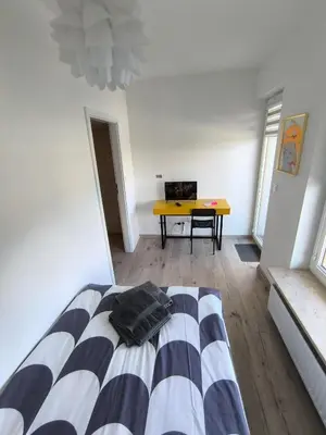 Łóżko lub łóżka w pokoju w obiekcie Pokoje Oszmiańska