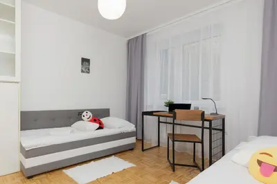 Łóżko lub łóżka w pokoju w obiekcie Family Apartment Bogatyńska Bemowo by Noclegi Renters