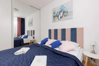 Łóżko lub łóżka w pokoju w obiekcie Family Apartment Bogatyńska Bemowo by Noclegi Renters