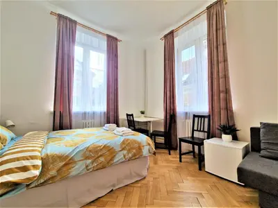 Łóżko lub łóżka w pokoju w obiekcie J&W Apartments Świętojańska Rooms