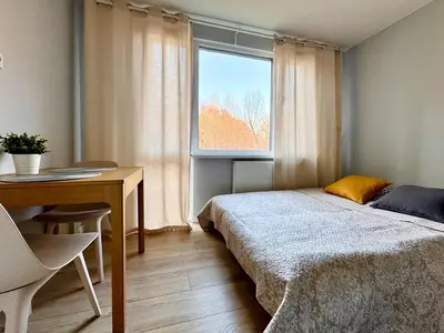 Łóżko lub łóżka w pokoju w obiekcie K22 Park Mokotow Aparts