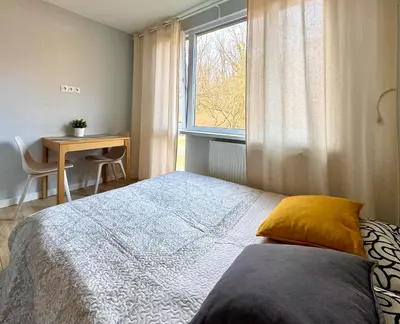 Łóżko lub łóżka w pokoju w obiekcie K22 Park Mokotow Aparts